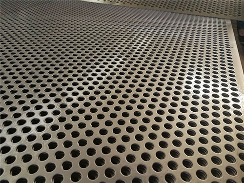 Perforated metal plates are stacked on the warehouse.